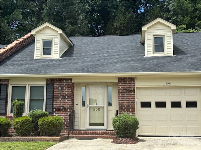 550 Camrose Cir NE, Concord, NC 28025 - new england style home with roof with shingles, brick siding, and an attached garage