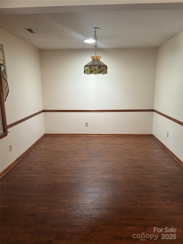 550 Camrose Cir NE, Concord, NC 28025 - empty room featuring dark wood-type flooring and baseboards