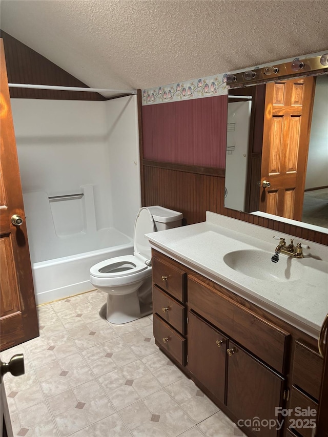550 Camrose Cir NE, Concord, NC 28025 - bathroom featuring a textured ceiling, vanity, toilet, tile patterned floors, and vaulted ceiling