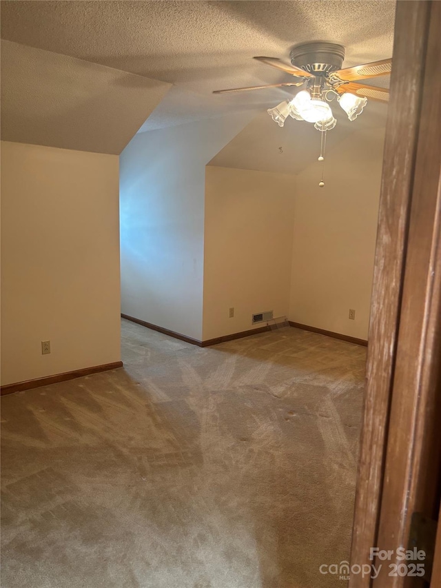 550 Camrose Cir NE, Concord, NC 28025 - additional living space with ceiling fan, carpet flooring, a textured ceiling, lofted ceiling, and baseboards