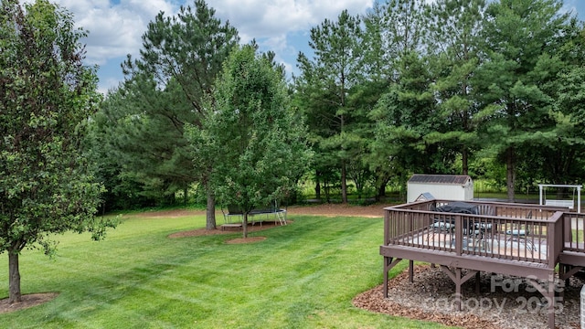 2843 Hopewell Church Rd, Sherrills Ford, NC 28673 - view of green lawn featuring a trampoline, a deck, and view of wooded area
