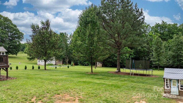 2843 Hopewell Church Rd, Sherrills Ford, NC 28673 - view of grassy yard featuring a trampoline and view of wooded area