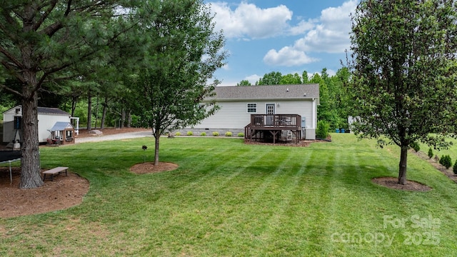 2843 Hopewell Church Rd, Sherrills Ford, NC 28673 - view of grassy yard with a wooden deck and a trampoline