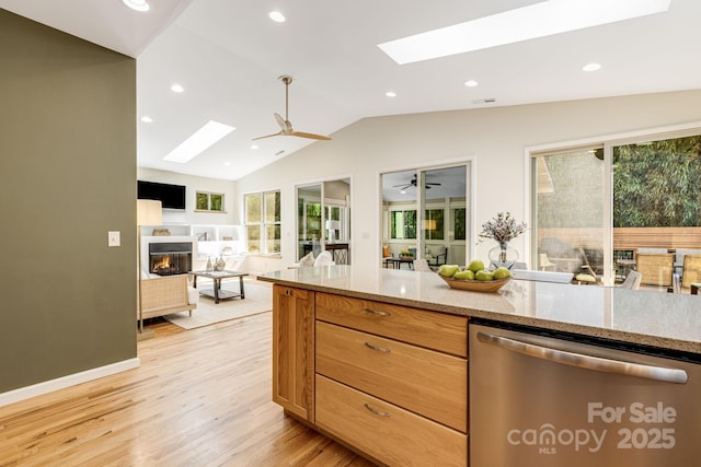 506 Hiawassee Ave, Black Mountain, NC 28711 - kitchen featuring a skylight, stainless steel dishwasher, a glass covered fireplace, lofted ceiling, and open floor plan