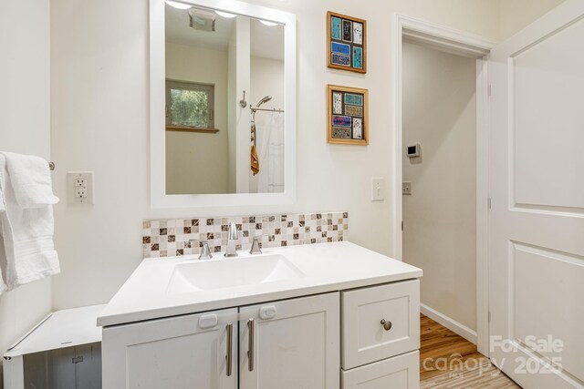 506 Hiawassee Ave, Black Mountain, NC 28711 - full bath featuring backsplash, vanity, and wood finished floors