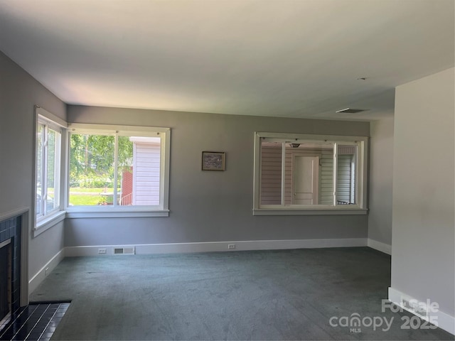 117 Silvercreek Rd, Morganton, NC 28655 - unfurnished living room featuring carpet floors, baseboards, and a tile fireplace