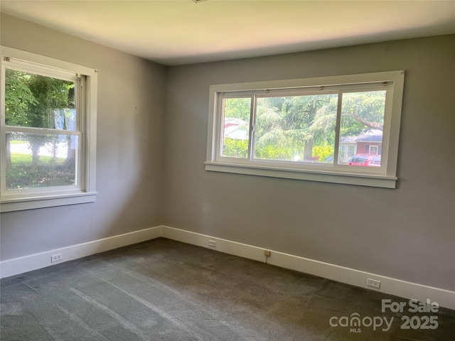 117 Silvercreek Rd, Morganton, NC 28655 - spare room with healthy amount of natural light, dark colored carpet, and baseboards