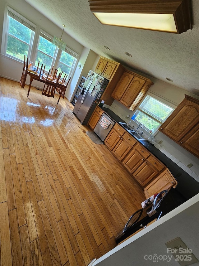 1670 Jamestown Rd, Morganton, NC 28655 - kitchen with healthy amount of natural light, light wood finished floors, a textured ceiling, and appliances with stainless steel finishes