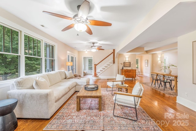 24 Warwick Rd, Asheville, NC 28803 - living area featuring wood finished floors, a ceiling fan, stairway, and baseboards