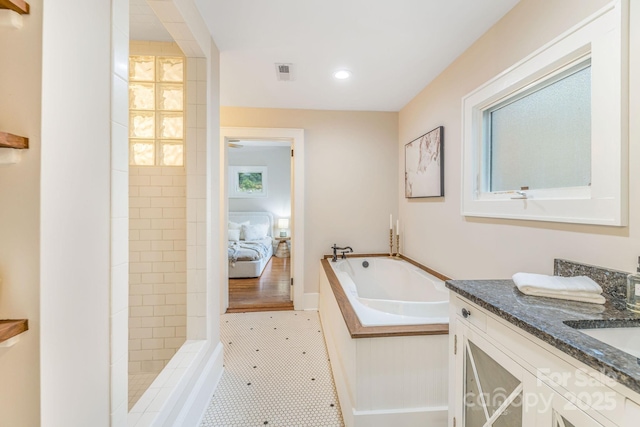 24 Warwick Rd, Asheville, NC 28803 - ensuite bathroom featuring vanity, a bath, tiled shower, and recessed lighting
