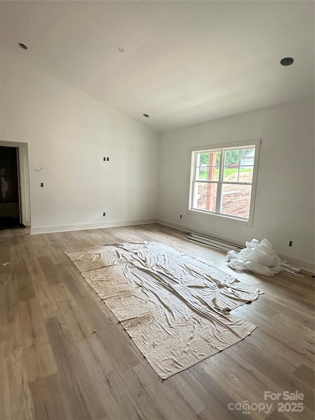63 Cornerstone Dr, Taylorsville, NC 28681 - unfurnished living room with light wood-type flooring, baseboard heating, baseboards, and vaulted ceiling