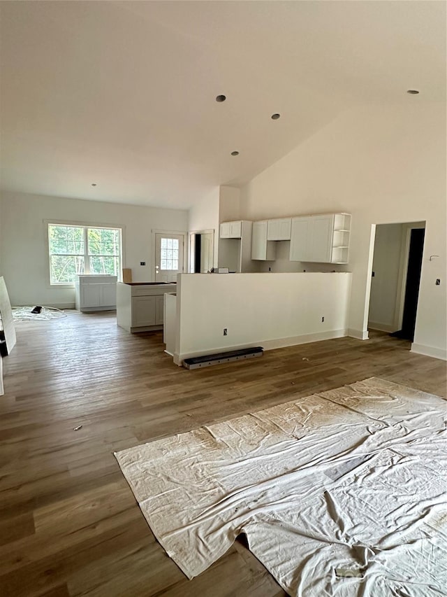 63 Cornerstone Dr, Taylorsville, NC 28681 - unfurnished living room featuring wood finished floors, baseboards, and high vaulted ceiling