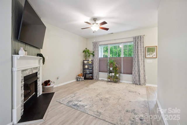 7931 Baylis Dr, Huntersville, NC 28078 - living area featuring wood finished floors, a ceiling fan, baseboards, and a fireplace
