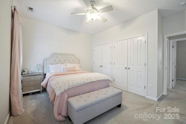 7931 Baylis Dr, Huntersville, NC 28078 - bedroom with light colored carpet, multiple closets, baseboards, and ceiling fan