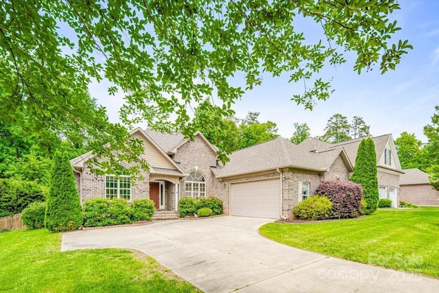 305 River Birch Cir, Mooresville, NC 28115 - traditional-style house with a garage, brick siding, a front yard, and concrete driveway