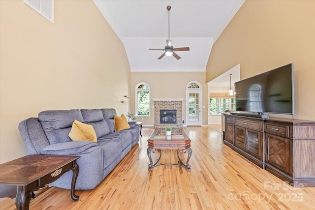 305 River Birch Cir, Mooresville, NC 28115 - living room featuring a ceiling fan, high vaulted ceiling, light wood-style floors, crown molding, and baseboards