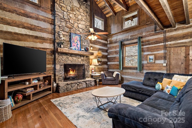 1495 El Miner Dr, Mars Hill, NC 28754 - living room featuring wooden ceiling with exposed beams, wooden walls, hardwood / wood-style floors, a fireplace, and ceiling fan