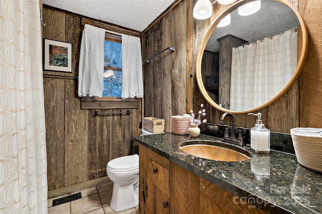 1495 El Miner Dr, Mars Hill, NC 28754 - bathroom with a textured ceiling, vanity, toilet, tile patterned floors, and wood walls