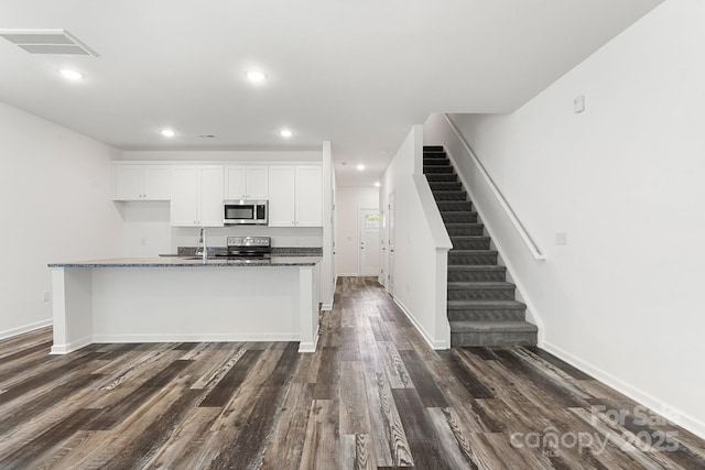 1112 Angle St, Cherryville, NC 28021 - kitchen with stainless steel appliances, white cabinets, dark wood-style floors, recessed lighting, and baseboards