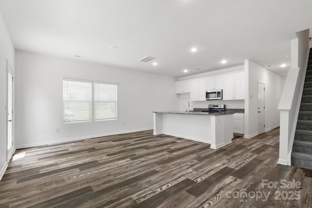 1112 Angle St, Cherryville, NC 28021 - kitchen featuring appliances with stainless steel finishes, recessed lighting, dark wood-style floors, dark countertops, and white cabinetry