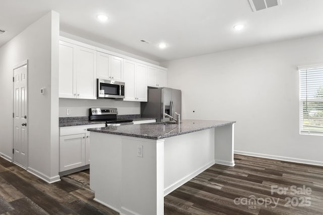 1112 Angle St, Cherryville, NC 28021 - kitchen featuring appliances with stainless steel finishes, dark wood-style floors, a kitchen island with sink, white cabinetry, and recessed lighting