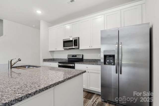 1112 Angle St, Cherryville, NC 28021 - kitchen with appliances with stainless steel finishes, a sink, white cabinetry, dark wood finished floors, and recessed lighting