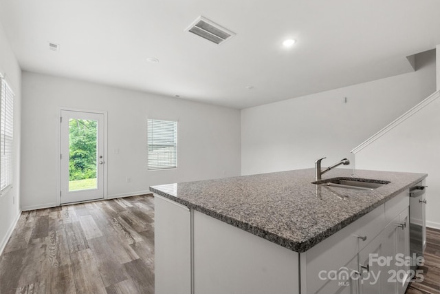 1112 Angle St, Cherryville, NC 28021 - kitchen featuring a sink, dark wood-style floors, baseboards, dark stone counters, and white cabinetry