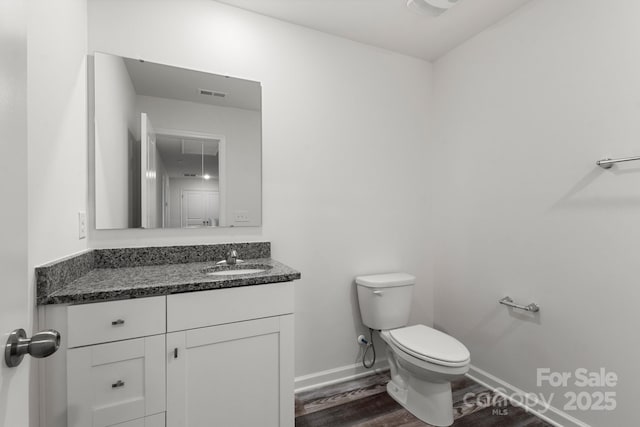 1112 Angle St, Cherryville, NC 28021 - bathroom featuring toilet, vanity, wood finished floors, and baseboards
