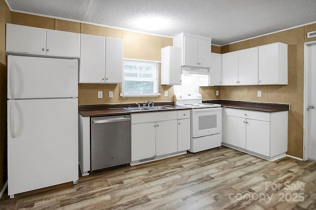 203 Bethlehem Church Rd, Grover, NC 28073 - kitchen featuring white appliances, dark countertops, a textured ceiling, light wood finished floors, and white cabinetry