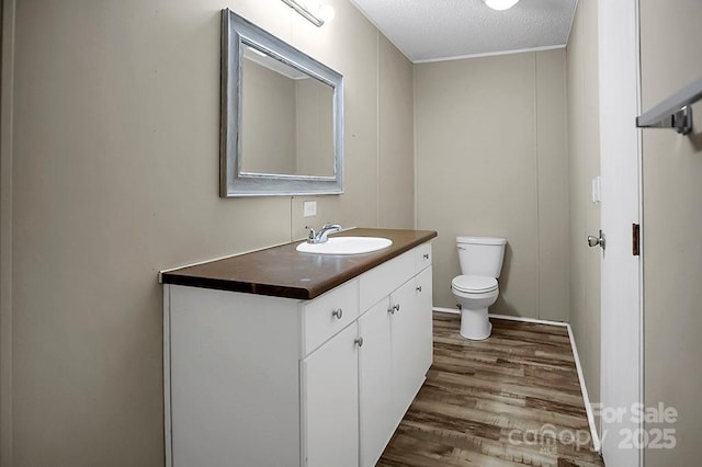 203 Bethlehem Church Rd, Grover, NC 28073 - half bathroom with wood finished floors, vanity, toilet, and a textured ceiling