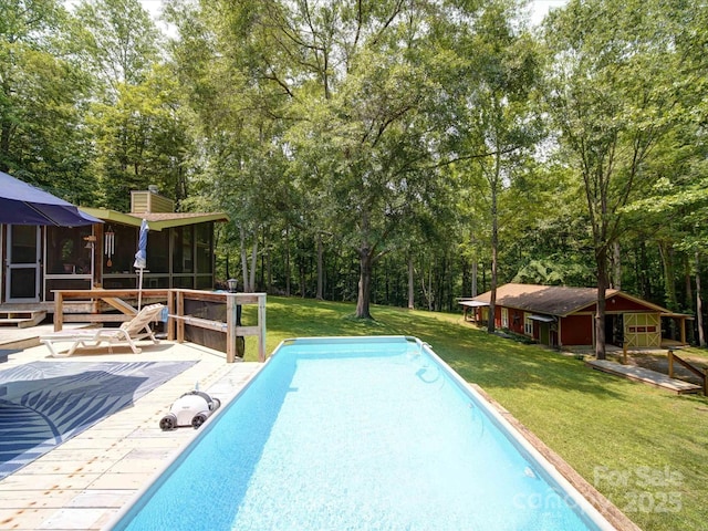 157 Old Hearth Rd, Clover, SC 29710 - swimming pool featuring a wooden deck, a yard, a sunroom, view of wooded area, and an outbuilding