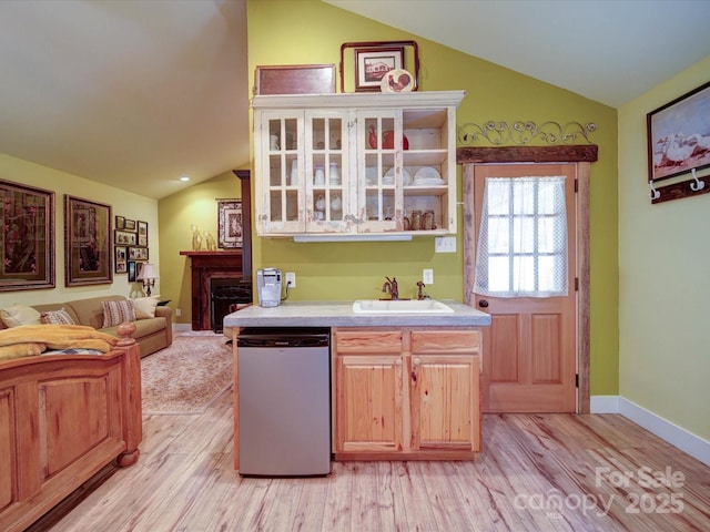 157 Old Hearth Rd, Clover, SC 29710 - kitchen with vaulted ceiling, a sink, dishwashing machine, light wood-style flooring, and light countertops