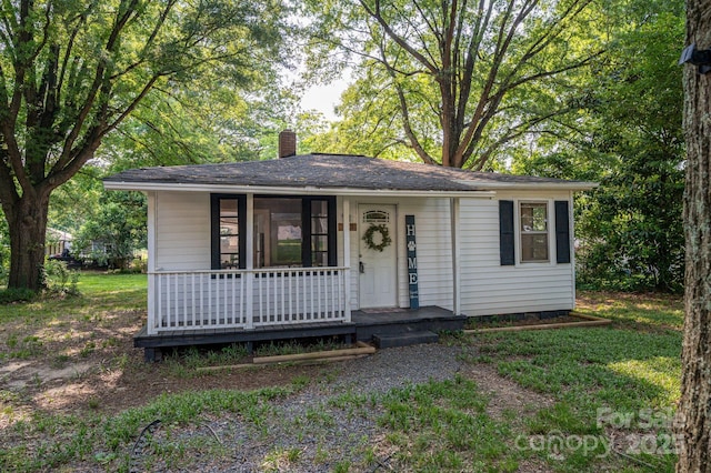 143 Hallman St, Cherryville, NC 28021 - view of front facade with a chimney and a porch