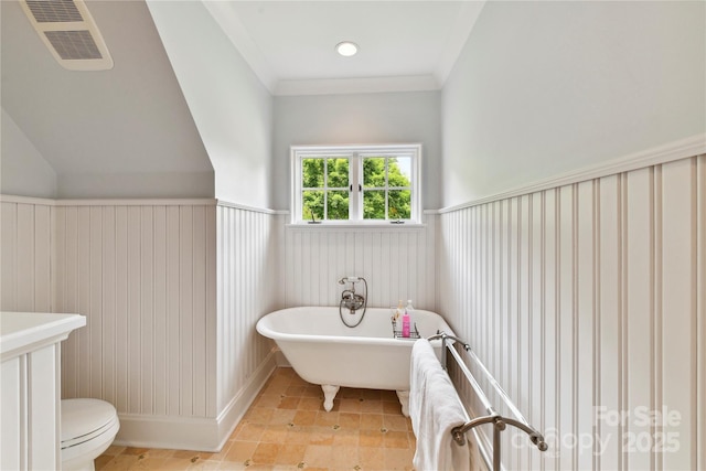 2240 La Maison Dr, Charlotte, NC 28226 - bathroom with a freestanding bath, toilet, and wainscoting