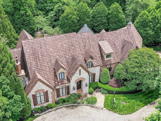 2240 La Maison Dr, Charlotte, NC 28226 - view of front facade with stone siding, a chimney, and a forest view