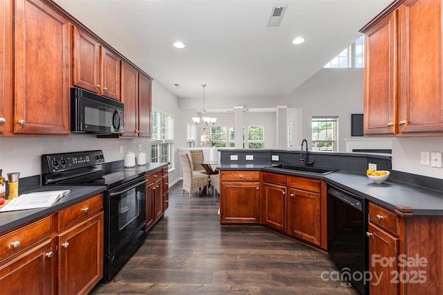10198 Tintinhull Dr, Fort Mill, SC 29707 - kitchen featuring black appliances, a sink, dark countertops, a chandelier, and dark wood-style floors