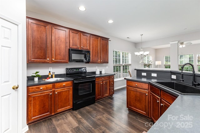 10198 Tintinhull Dr, Fort Mill, SC 29707 - kitchen with black appliances, a sink, dark countertops, dark wood finished floors, and recessed lighting