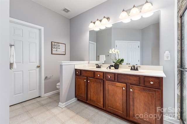 10198 Tintinhull Dr, Fort Mill, SC 29707 - full bathroom with baseboards, double vanity, toilet, and tile patterned floors