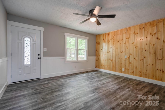 1010 Fallston Rd, Shelby, NC 28150 - entrance foyer featuring a textured ceiling, wood finished floors, ceiling fan, wood walls, and a wainscoted wall