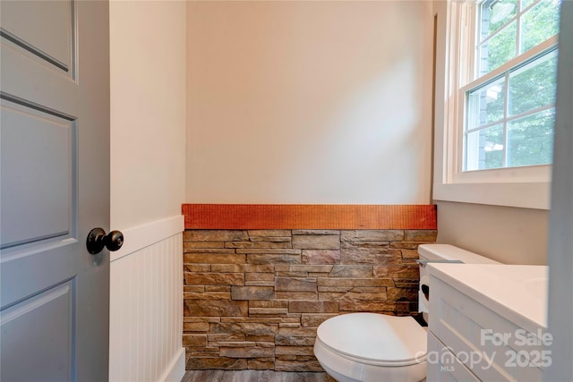1010 Fallston Rd, Shelby, NC 28150 - half bath featuring toilet, a wainscoted wall, vanity, and a decorative wall