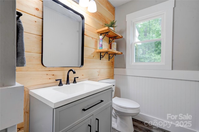 1010 Fallston Rd, Shelby, NC 28150 - bathroom with toilet, vanity, wooden walls, wainscoting, and wood finished floors