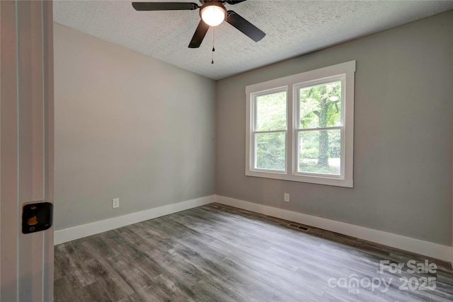 1010 Fallston Rd, Shelby, NC 28150 - unfurnished room with a textured ceiling, wood finished floors, baseboards, and a ceiling fan