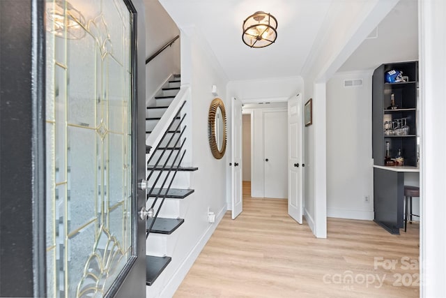 1119 Thornsby Ln, Matthews, NC 28105 - entryway featuring wood finished floors, stairway, ornamental molding, and baseboards