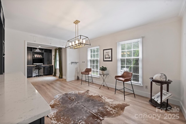 1119 Thornsby Ln, Matthews, NC 28105 - dining room featuring crown molding, a desk, light wood finished floors, baseboards, and a chandelier