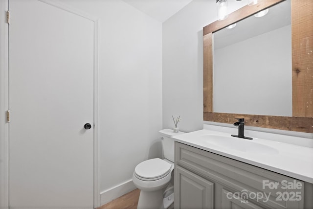 1119 Thornsby Ln, Matthews, NC 28105 - bathroom with vanity, toilet, wood finished floors, and baseboards