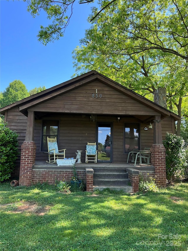 850AND830 E NC-152 Hwy E, China Grove, NC 28023 - view of front facade featuring a porch, a front lawn, and a chimney