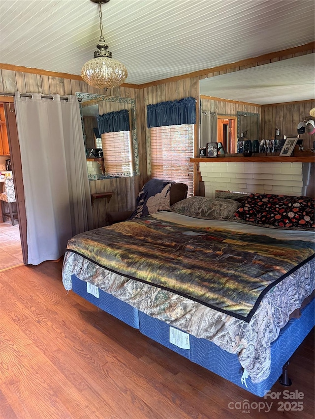 850AND830 E NC-152 Hwy E, China Grove, NC 28023 - bedroom with wood finished floors, wooden walls, and a chandelier