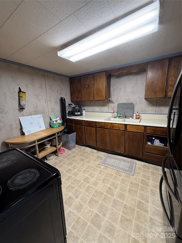 850AND830 E NC-152 Hwy E, China Grove, NC 28023 - kitchen with electric range, light countertops, freestanding refrigerator, wallpapered walls, and light flooring