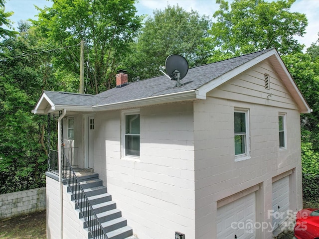 121 Patrick St, Gastonia, NC 28054 - view of side of home featuring a shingled roof, a chimney, and a garage