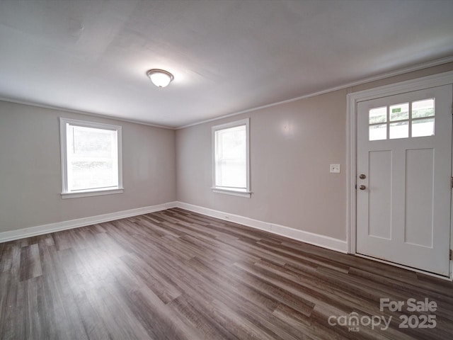 121 Patrick St, Gastonia, NC 28054 - foyer entrance with ornamental molding, dark wood-style floors, plenty of natural light, and baseboards